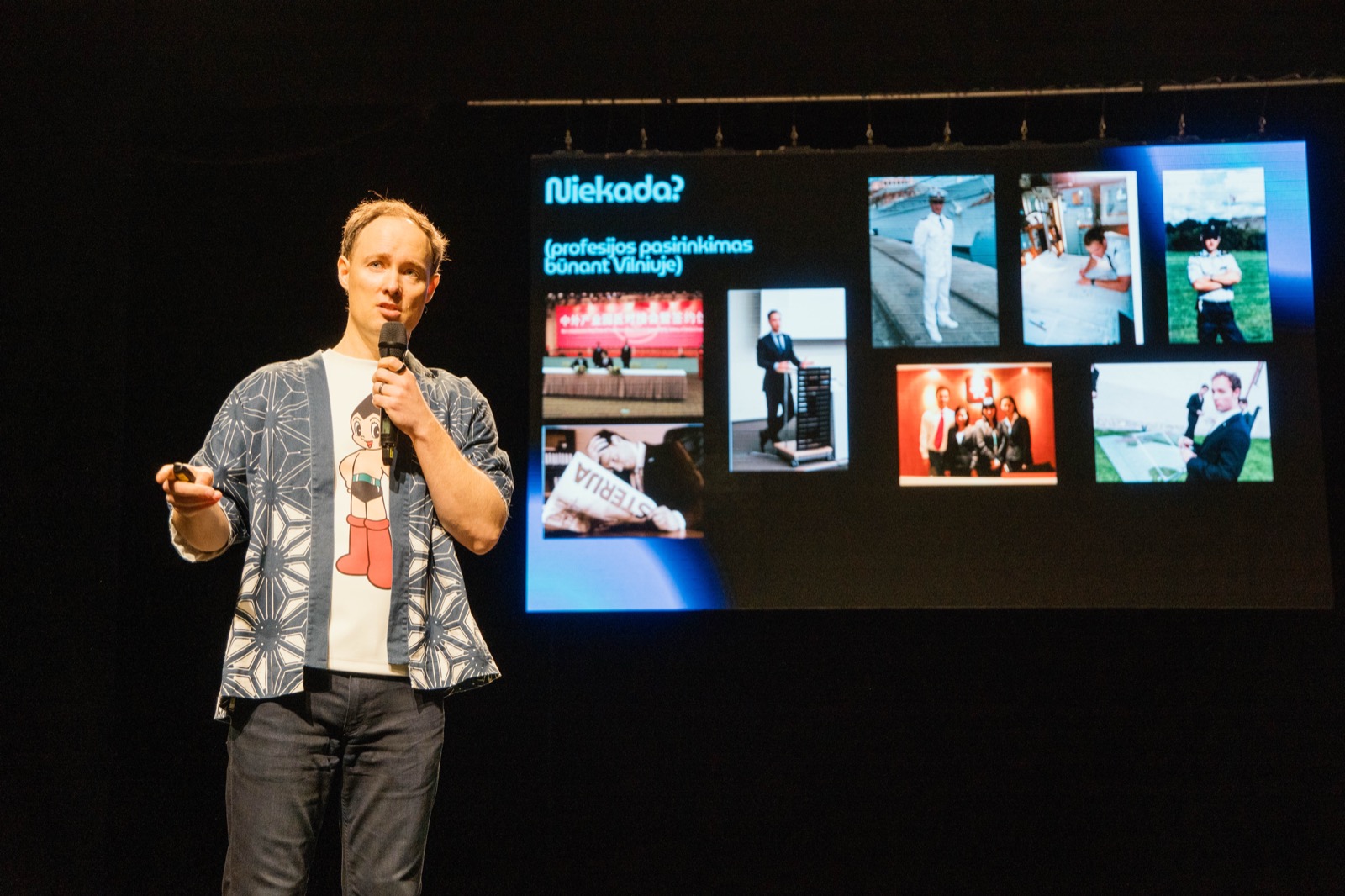 Martynas Kairys speaking at a regional inspiration day for students, career-path photos on the screen behind him